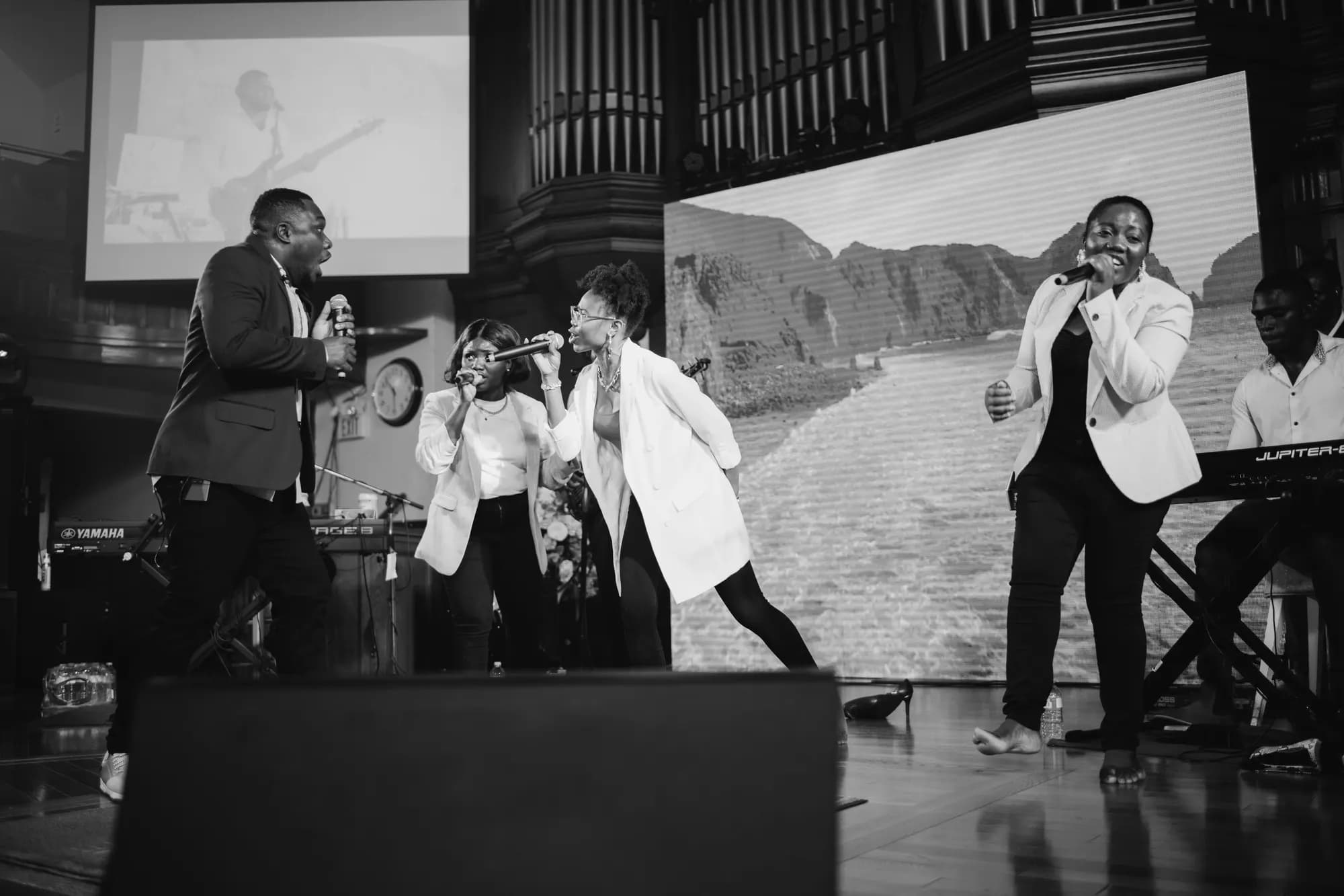 Black and white photograph of the live band on stage during ministration.